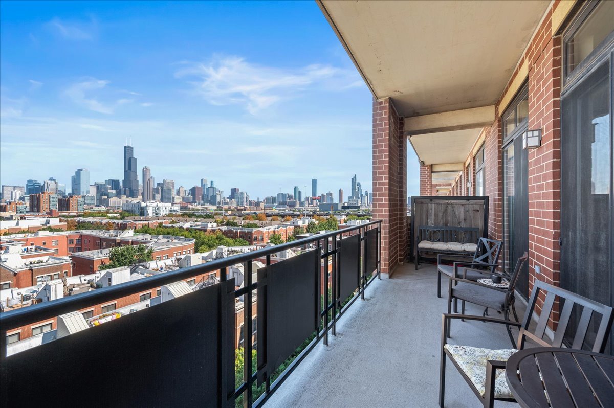 811 West 15th Place, Unit 708 Chicago, IL 60608 - Photo 16 of 28 a city view from a balcony with chairs