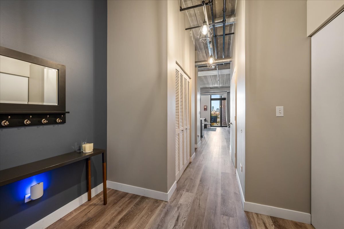 811 West 15th Place, Unit 708 Chicago, IL 60608 - Photo 21 of 28 a view of a hallway with wooden floor and a fireplace