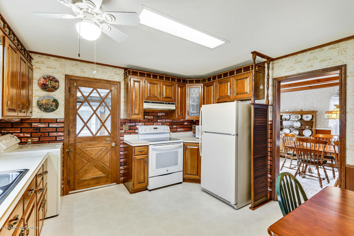 63 Cannon Road Freehold, NJ 07728 - Photo 17 of 34 a kitchen with stainless steel appliances granite countertop a chimney a sink and a refrigerator