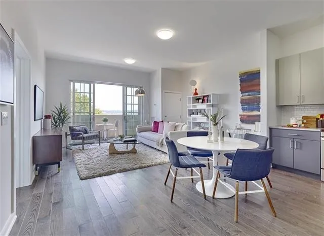 a living room with furniture kitchen and a table