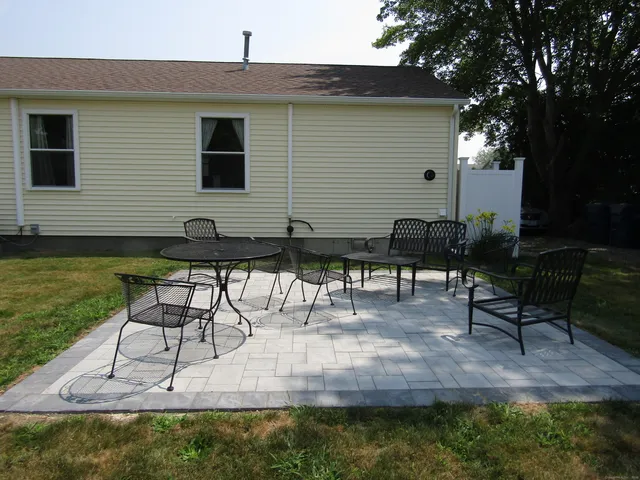 a view of backyard with sitting area