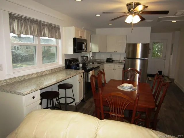 a room with furniture a flat screen tv and a window