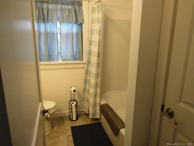 a bed sitting in a bedroom and wooden floor