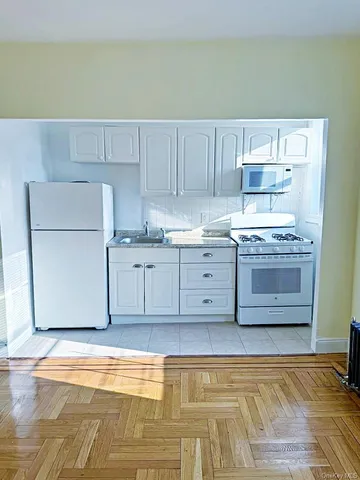 a view of kitchen with wooden floor