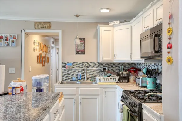 a kitchen with stainless steel appliances a stove a sink and a refrigerator