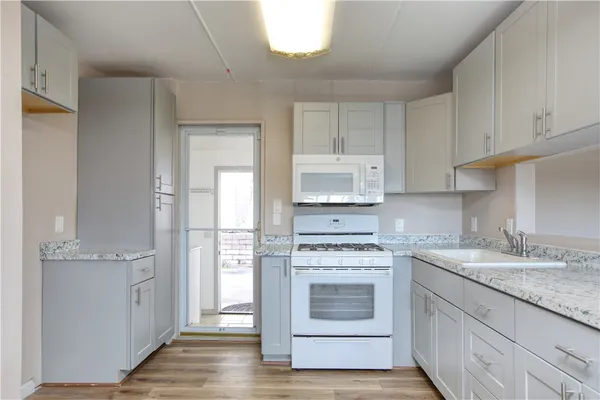 a kitchen with a stove top oven sink and cabinets