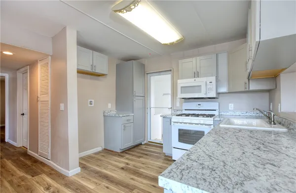 a kitchen with a sink stove and refrigerator
