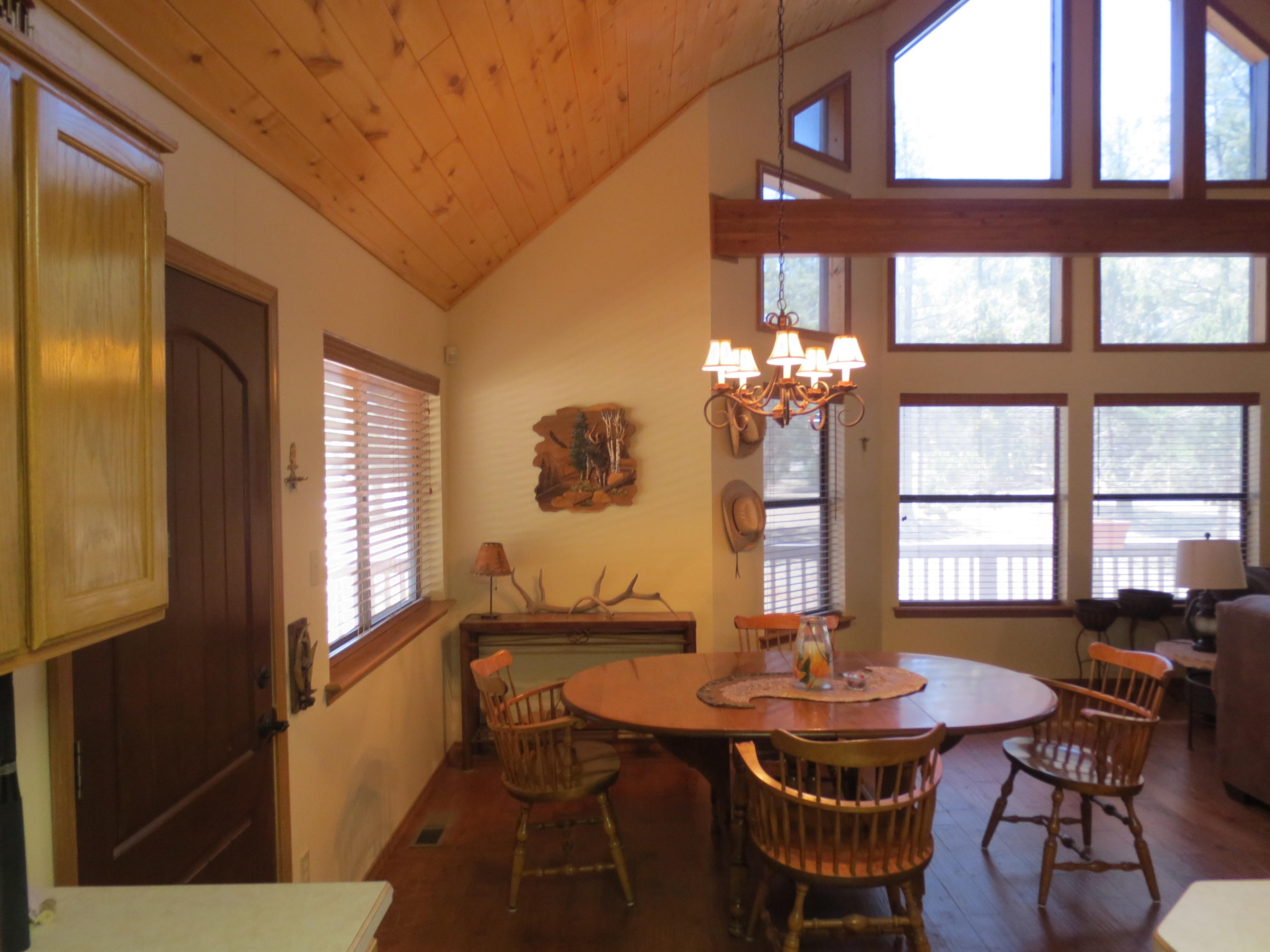 2970 Monica Road Overgaard, AZ 85933 - Photo 26 of 37 a view of a dining room with furniture a chandelier and wooden floor