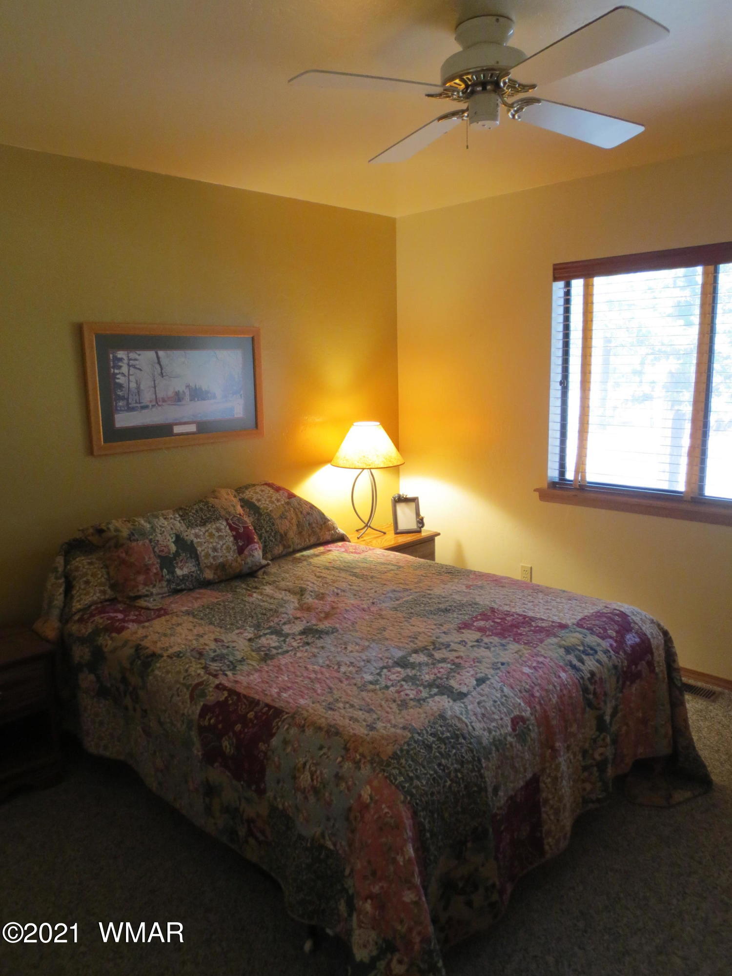 2970 Monica Road Overgaard, AZ 85933 - Photo 29 of 37 a bedroom with a bed and window