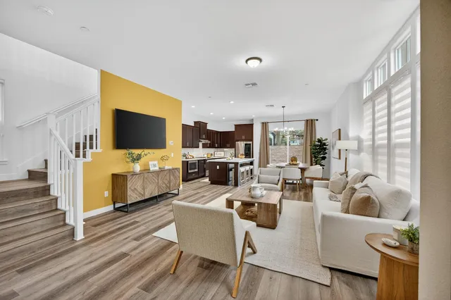 a living room with furniture flat screen tv and a fireplace