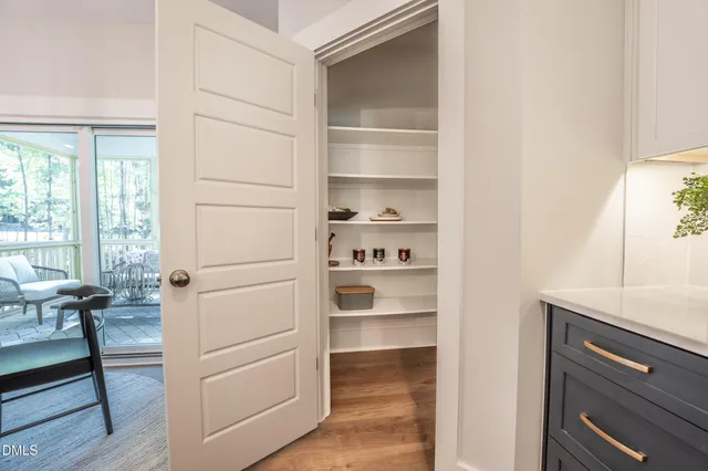 a view of walk in closet with empty racks
