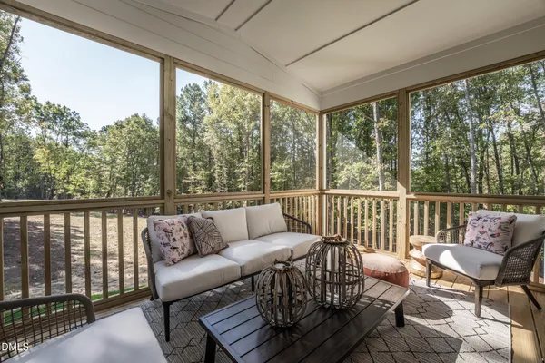 a view of a balcony with a large window and wooden floor