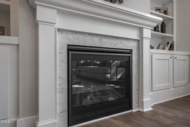 a view of a hallway with wooden floor and living room