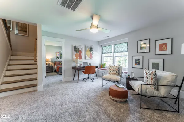 a spacious bedroom with a large bed and a chandelier