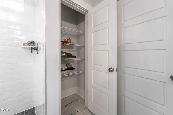 a spacious bathroom with a shower sink and mirror
