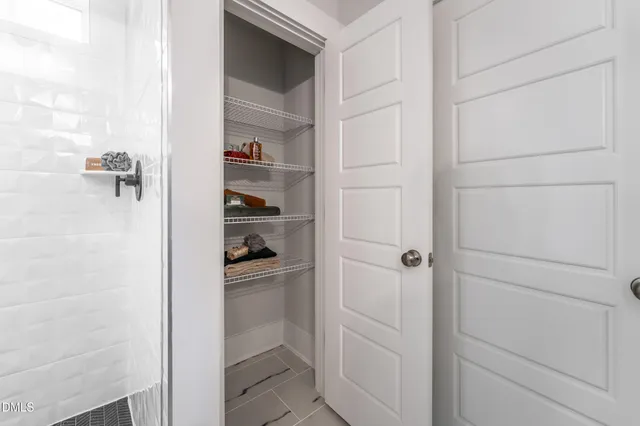 a spacious bathroom with a shower sink and mirror