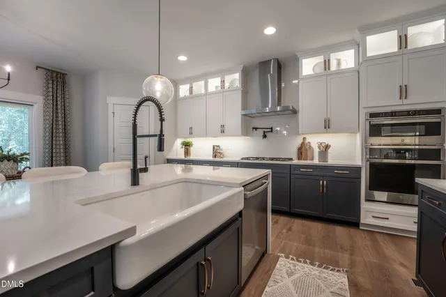 a kitchen with a sink cabinets and appliances