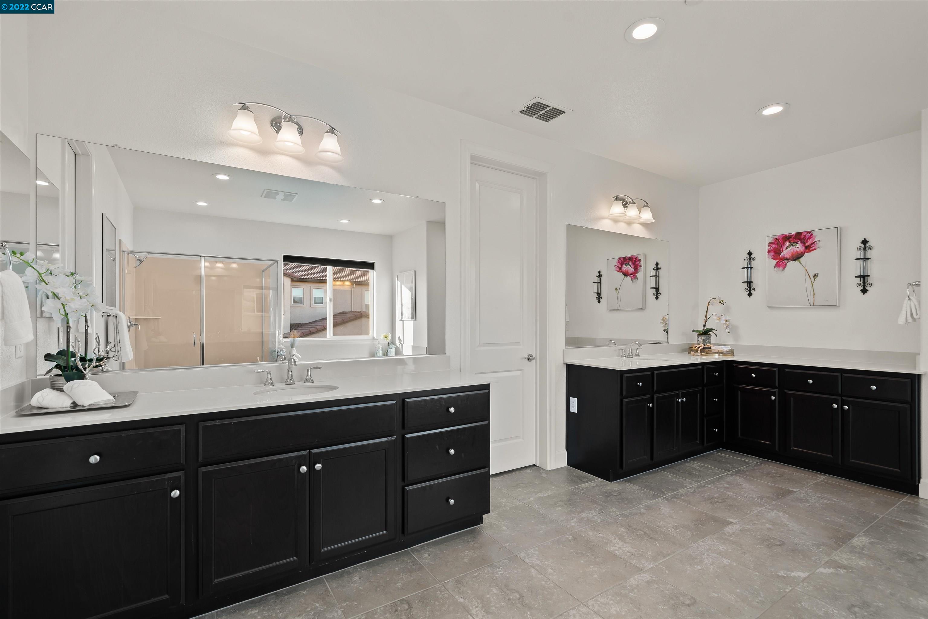 2468 Flag Stop Way Tracy, CA 95377 - Photo 16 of 36 a spacious bathroom with a granite countertop double vanity sink and a mirror