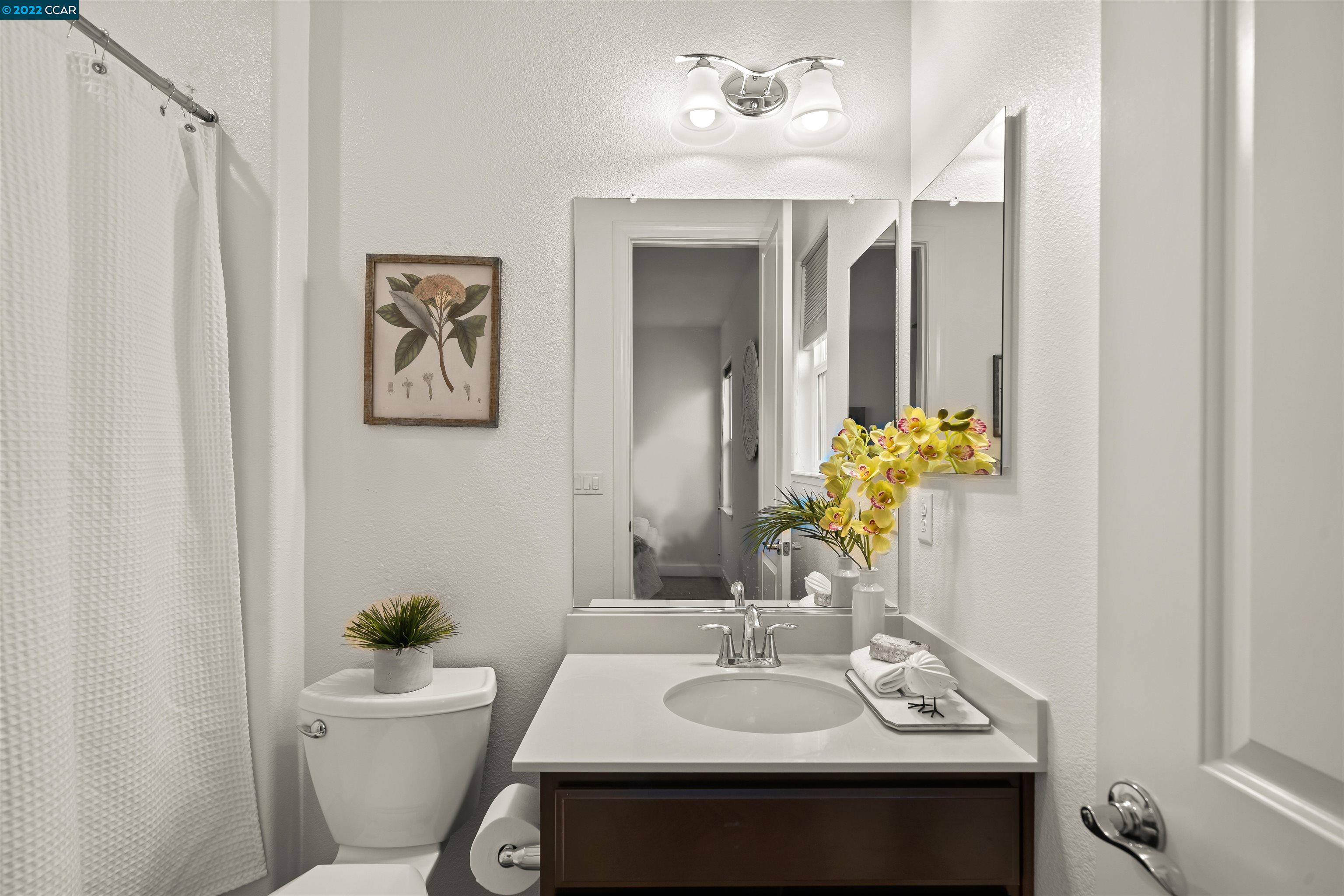 2468 Flag Stop Way Tracy, CA 95377 - Photo 20 of 36 a bathroom with a sink mirror vanity and toilet