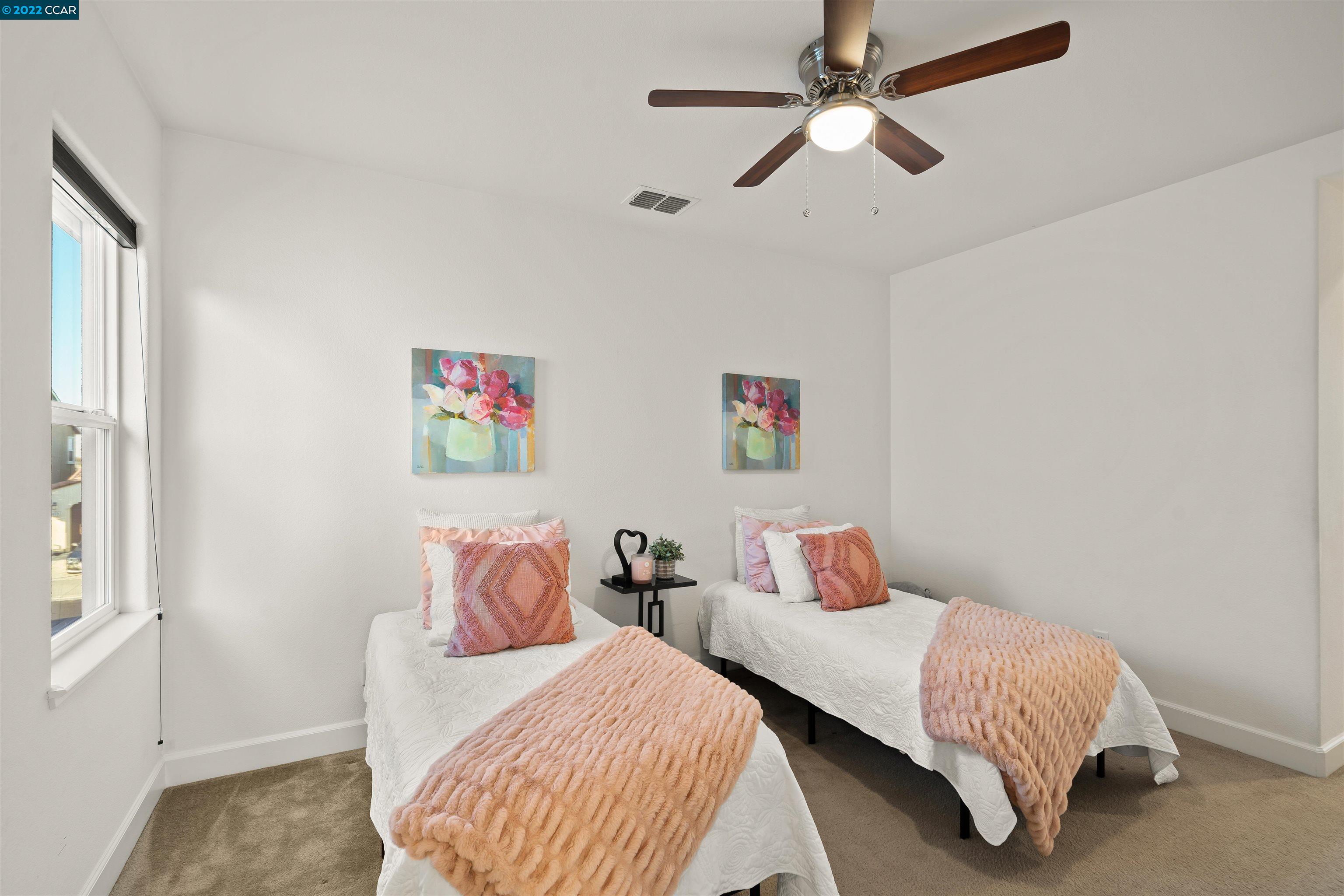 2468 Flag Stop Way Tracy, CA 95377 - Photo 21 of 36 a bedroom with two beds and a chandelier