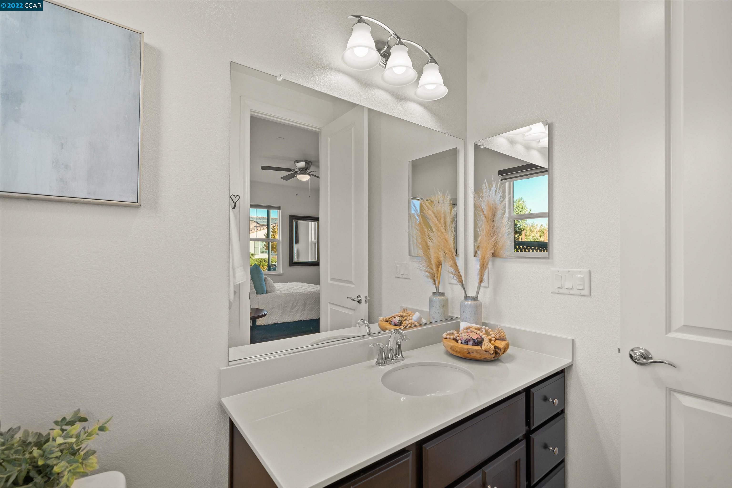 2468 Flag Stop Way Tracy, CA 95377 - Photo 22 of 36 a bathroom with a sink and a mirror