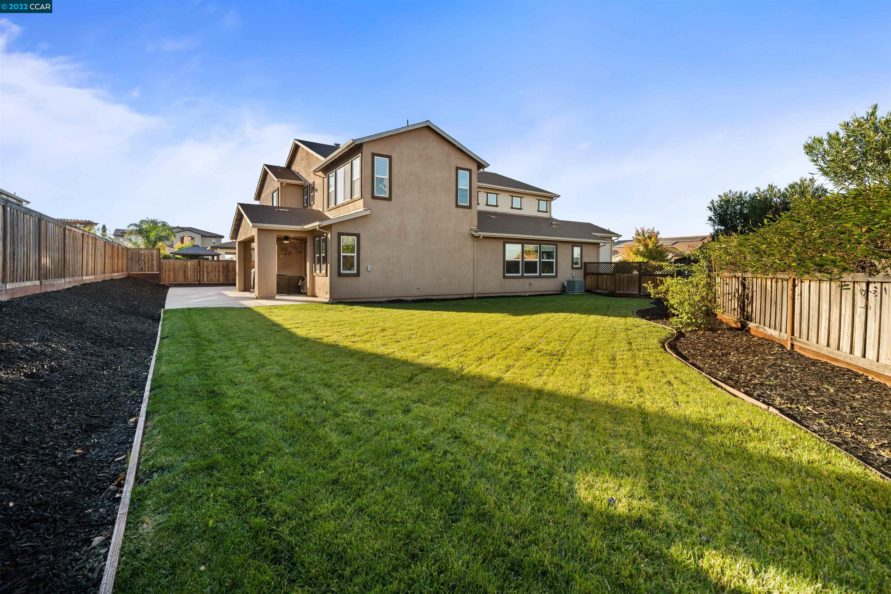 2468 Flag Stop Way Tracy, CA 95377 - Photo 27 of 36 a view of a house with a yard and deck