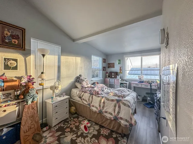 a bed room with furniture and a large window