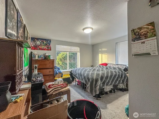 a bedroom with furniture and a window