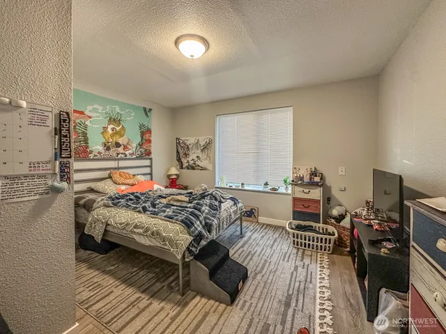 a bedroom with furniture and a wooden floor
