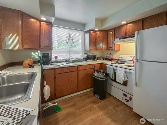 a kitchen with a sink appliances and cabinets