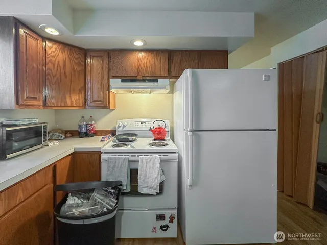 a kitchen with a refrigerator and a sink