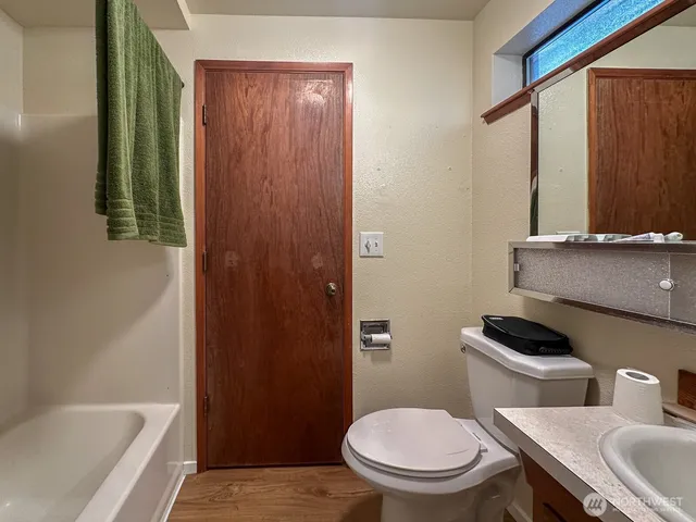 a bathroom with a toilet a sink and bathtub