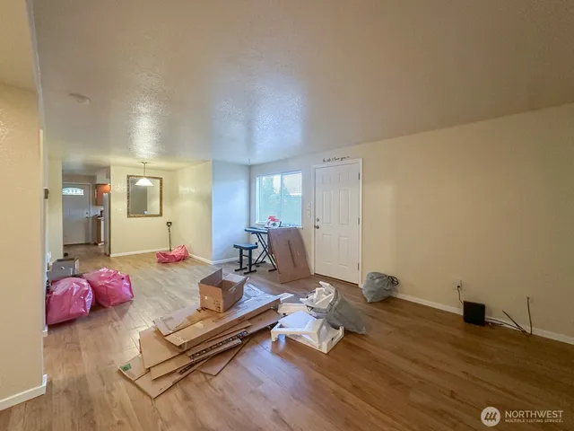 a living room with furniture pool table and gym equipment
