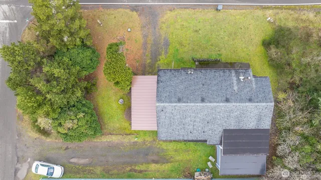 an aerial view of a house with a yard