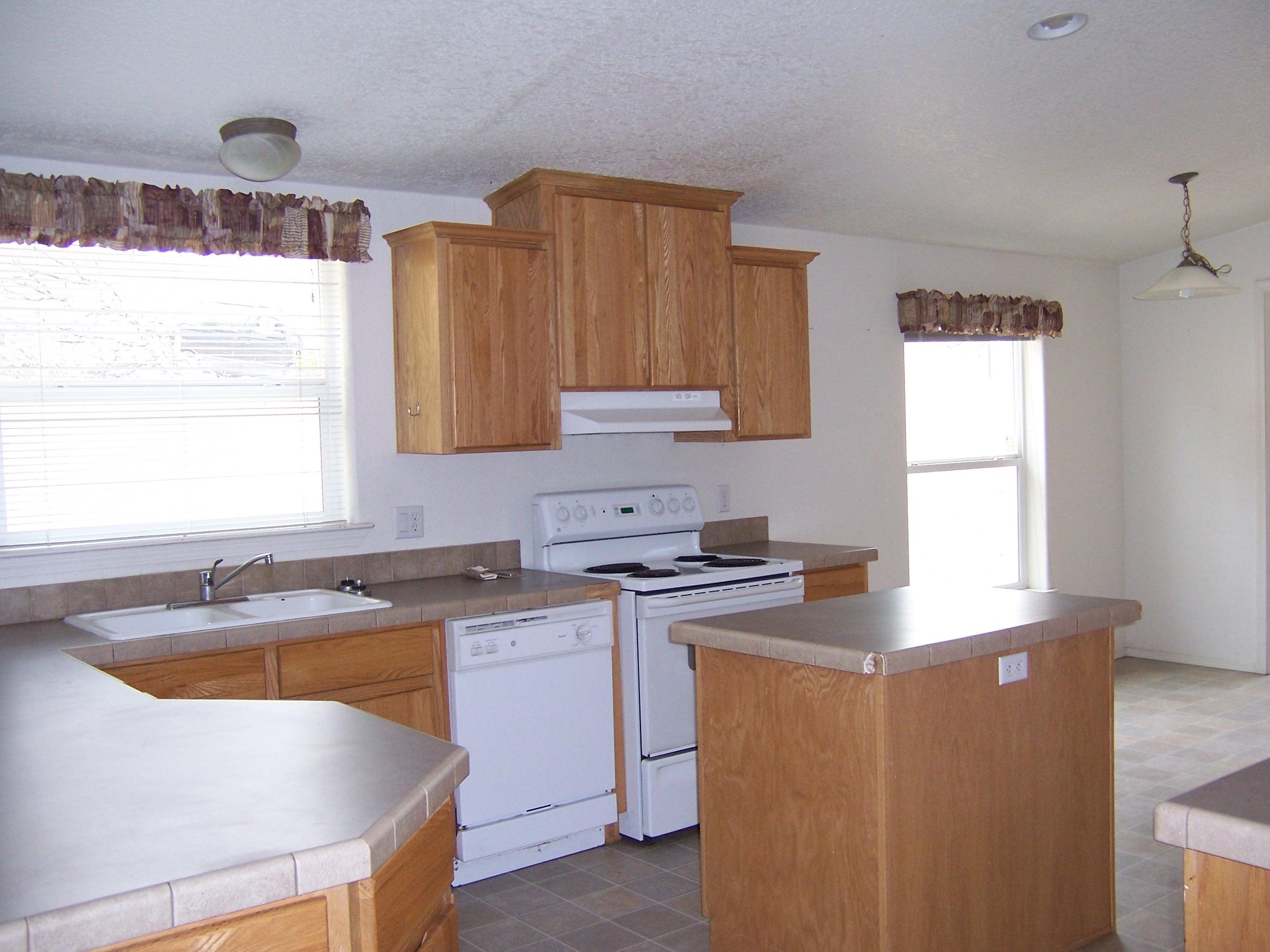 17010 Robinhill Road Corning, CA 96021 - Photo 4 of 7 a kitchen with stainless steel appliances granite countertop a sink a stove a counter space and cabinets