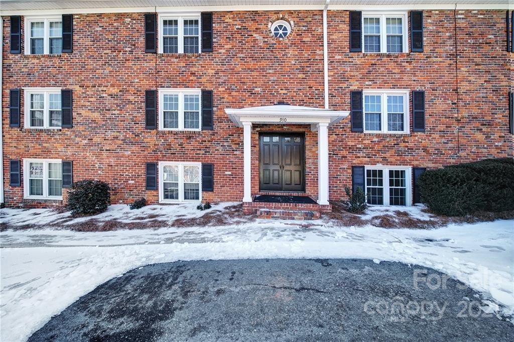 a front view of a building with a yard