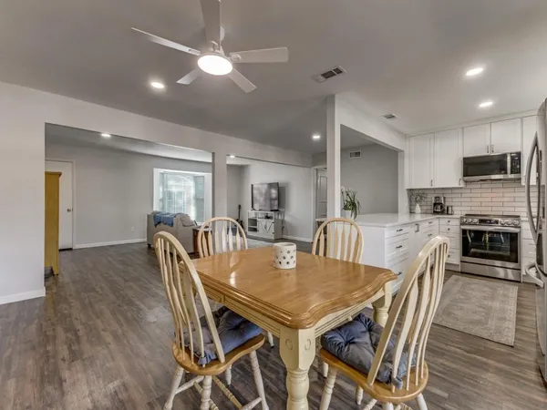 a view of a dining room with furniture and wooden floor