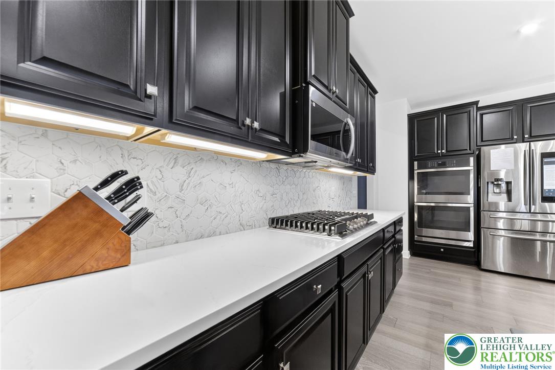 3952 Orth Street Bethlehem, PA 18020 - Photo 11 of 60 Culinary creations come to life in this kitchen, featuring sleek cabinetry and modern appliances.