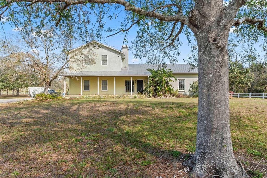 403 Indian Meadow Court Wimauma, FL 33598 - Photo 1 of 66 a front view of a house with a garden