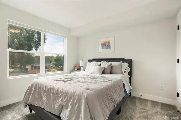 a bedroom with a bed and a mirror