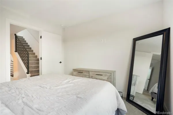 a bedroom with a bed and flat screen tv