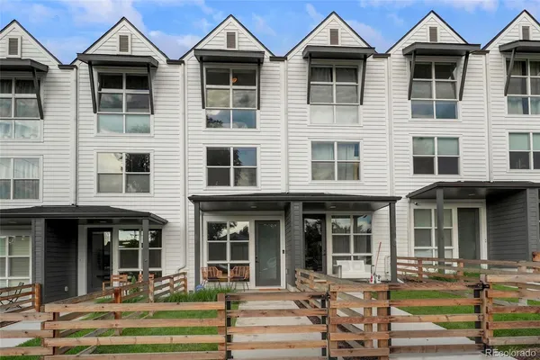 a front view of a residential apartment building with a yard