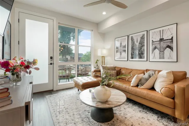 a living room with furniture and a large window with wooden floor