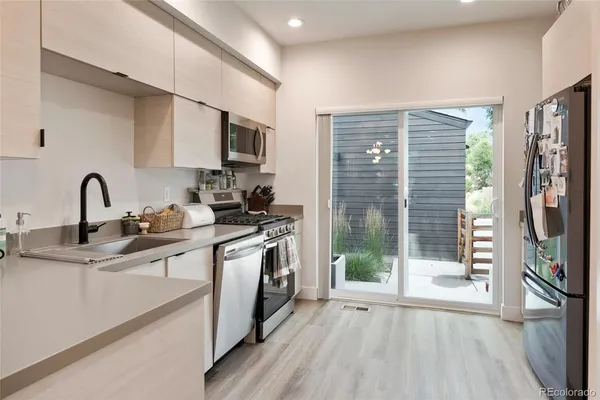 a kitchen with stainless steel appliances a sink stove and cabinets