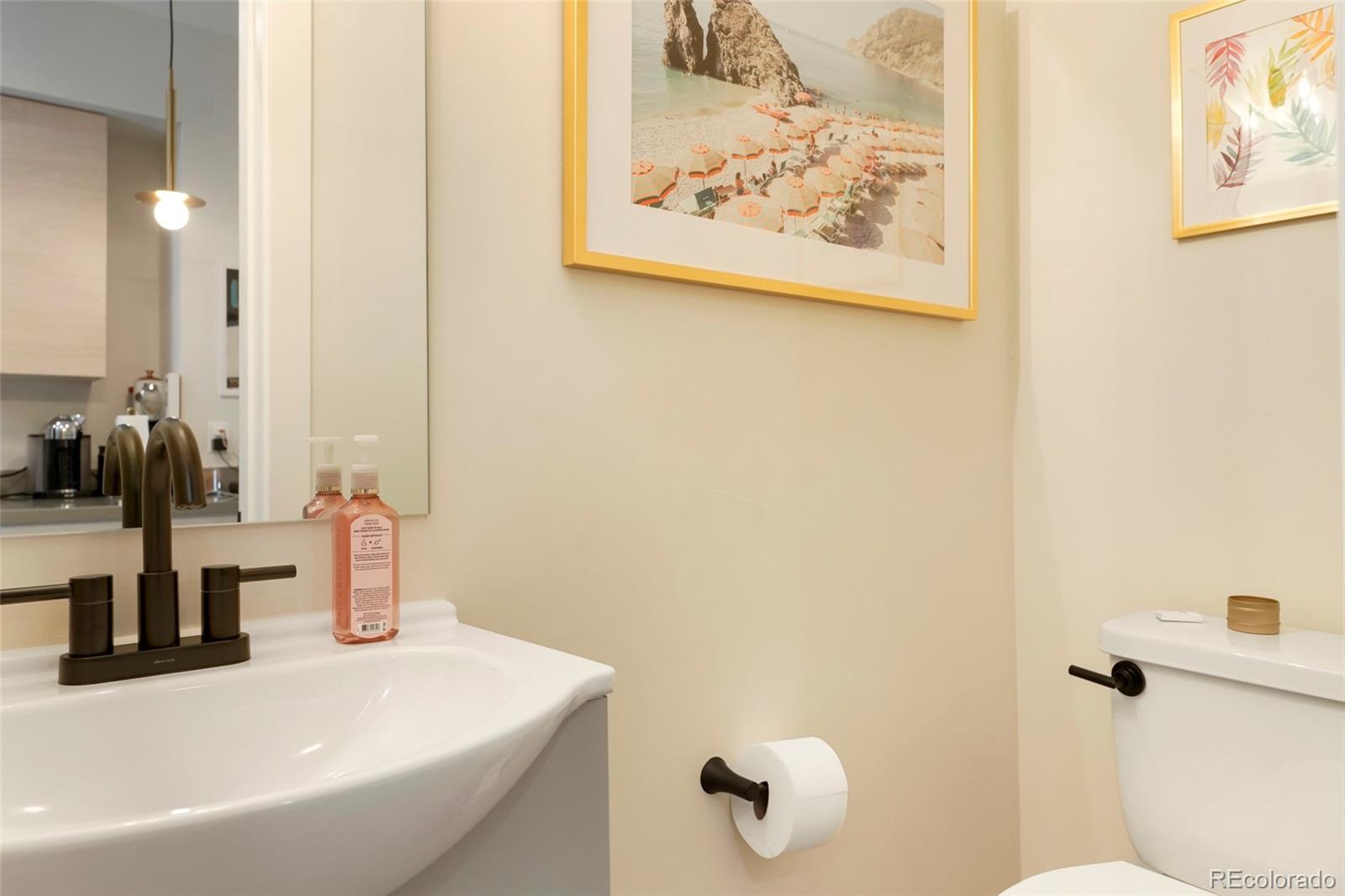 1082 King Street Denver, CO 80204 - Photo 9 of 21 a bathroom with a sink and a mirror