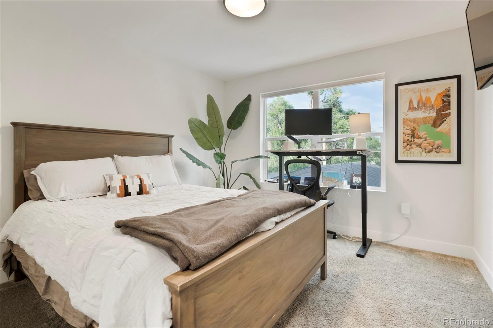 1082 King Street Denver, CO 80204 - Photo 10 of 21 a bedroom with a bed and a flat screen tv