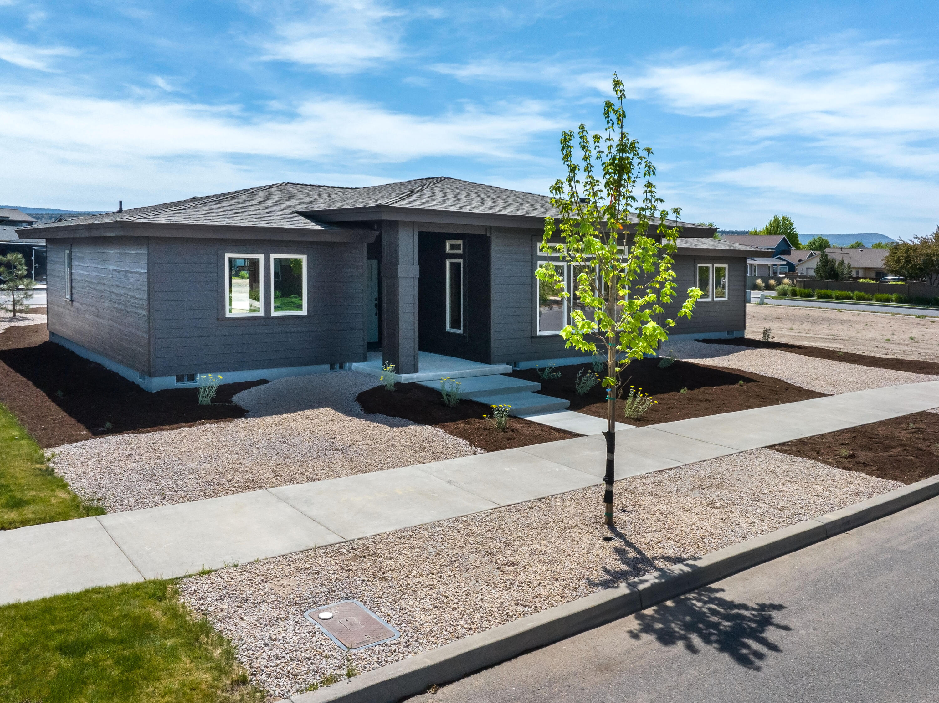 1472 Northeast Hudspeth Road Prineville, OR 97754 - Photo 3 of 26 a front view of a house with a yard and garage