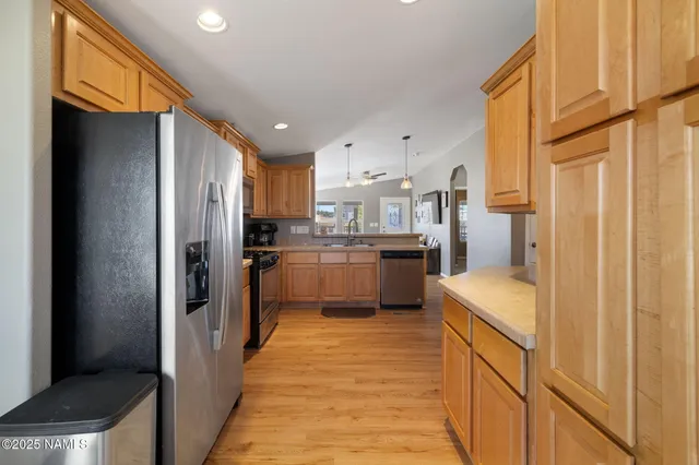 a kitchen with stainless steel appliances granite countertop refrigerator and a sink