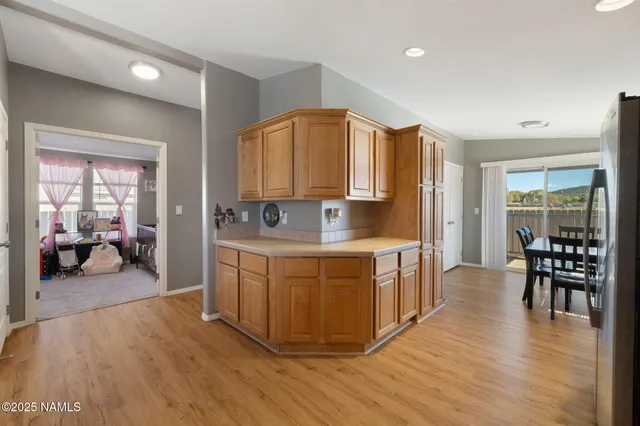 a large kitchen with stainless steel appliances granite countertop a stove a sink and a wooden cabinets