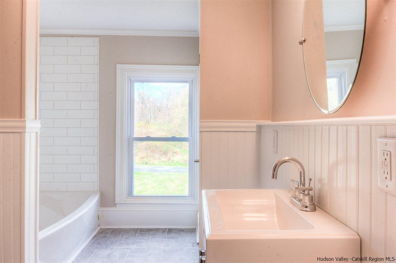 455 Plattekill Ardonia Road Wallkill, NY 12589 - Photo 23 of 24 a bathroom with a bathtub a sink and a window